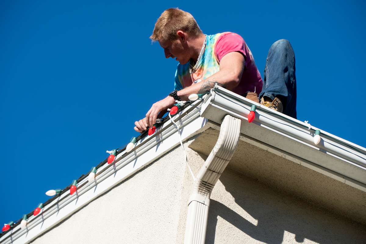 Handyman Installing Christmas Lights